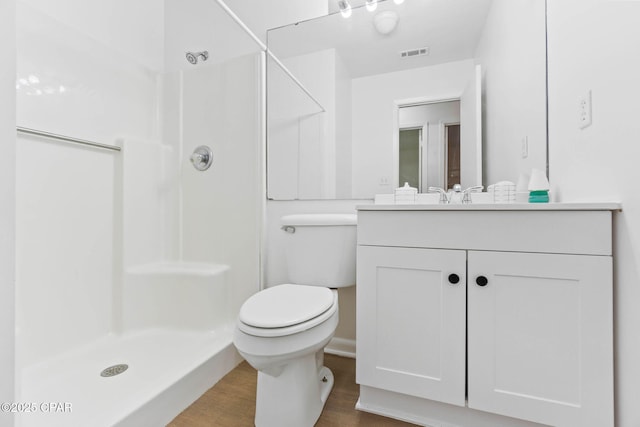 10367 NW County Road 274, Altha, FL 32421 - bathroom with a stall shower, wood finished floors, vanity, and toilet