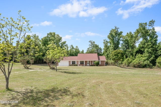 10367 NW County Road 274, Altha, FL 32421 - view of grassy yard with an attached garage