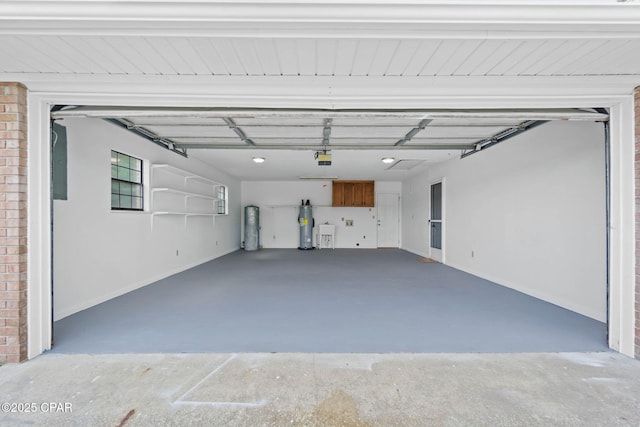 10367 NW County Road 274, Altha, FL 32421 - garage with water heater, a garage door opener, and baseboards