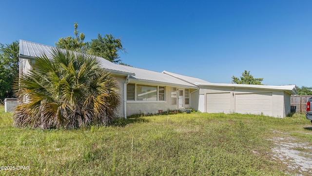 4949 E 2nd St, Panama City, FL 32404 - single story home with metal roof, a garage, and central AC