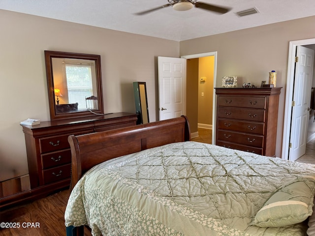 bedroom with baseboards, ceiling fan, and wood finished floors