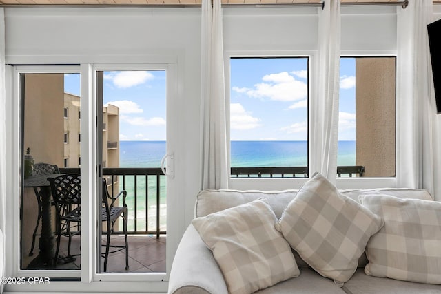 bedroom with a water view and access to outside