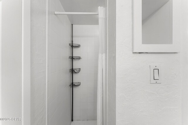 23223 Front Bch Unit A-Ph30, Panama City Beach, FL 32413 - full bath with a tile shower and a textured wall