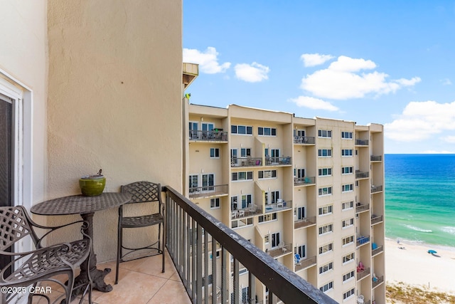 balcony featuring view of water and beach