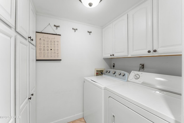 laundry room with cabinet space, washer and dryer, and ornamental molding