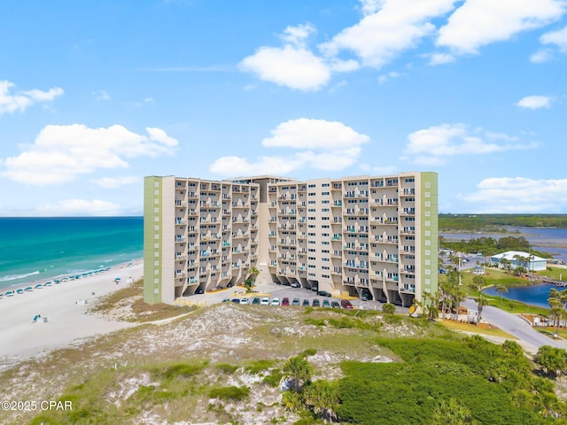 drone / aerial view of apartment complex / building and expansive coastline