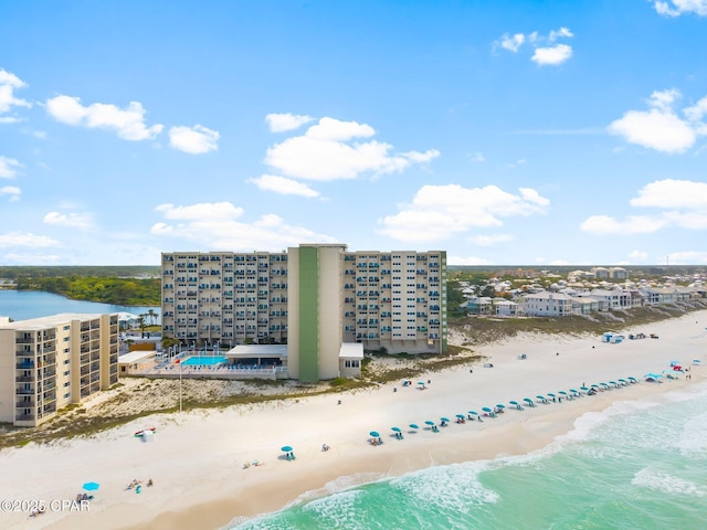 drone / aerial view of expansive coastline and apartment complex