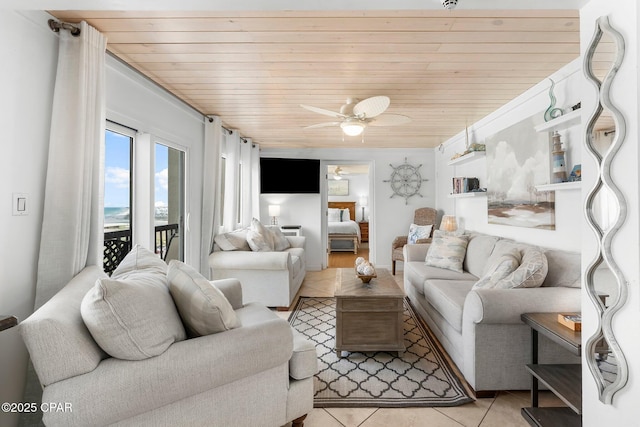 living area with light tile patterned flooring, wooden ceiling, and ceiling fan