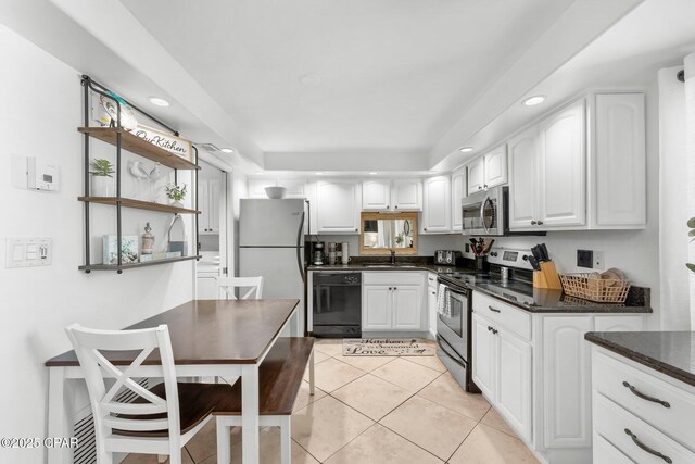 23223 Front Bch Unit A-Ph30, Panama City Beach, FL 32413 - kitchen with appliances with stainless steel finishes, a sink, white cabinetry, light tile patterned flooring, and recessed lighting