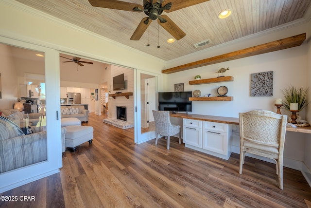 living room featuring a ceiling fan, ornamental molding, a brick fireplace, recessed lighting, and wood finished floors