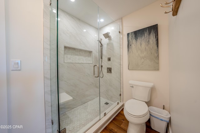 full bath featuring toilet, a stall shower, wood finished floors, and recessed lighting