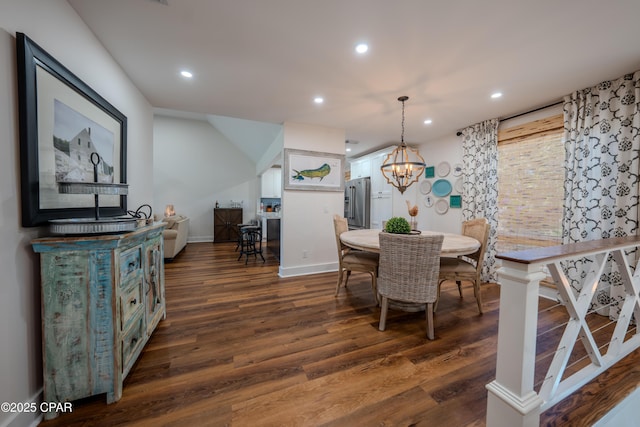 dining space featuring dark wood finished floors, recessed lighting, baseboards, and a chandelier