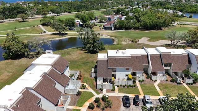 aerial perspective of suburban area with a nearby body of water and a golf club