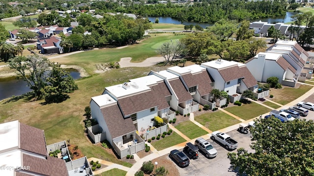 aerial perspective of suburban area with a large body of water and a local golf course