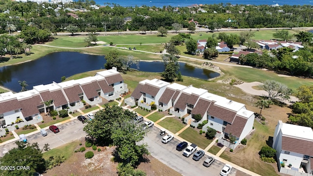aerial perspective of suburban area featuring a large body of water, a local golf course, and a tree filled landscape