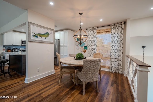 dining space with a chandelier, dark wood-type flooring, and recessed lighting
