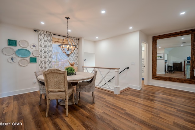 dining space with baseboards, wood finished floors, a chandelier, and recessed lighting