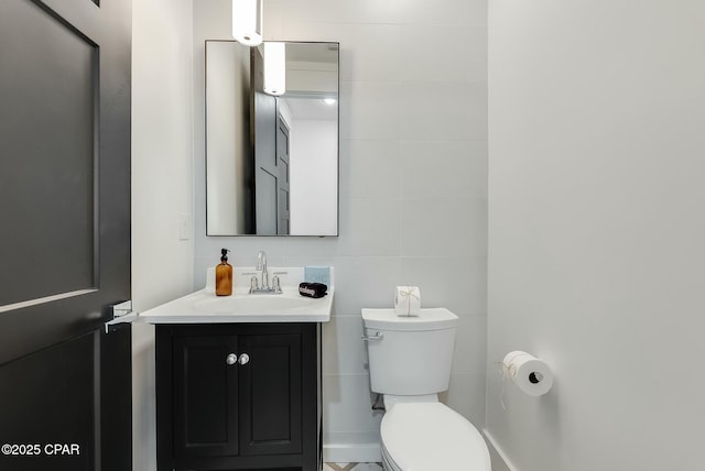208 George C Wallace, Panama City Beach, FL 32413 - bathroom with toilet, vanity, and tile walls