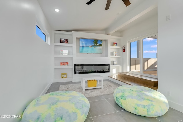 208 George C Wallace, Panama City Beach, FL 32413 - living area featuring a glass covered fireplace, ceiling fan, tile patterned floors, beam ceiling, and built in features