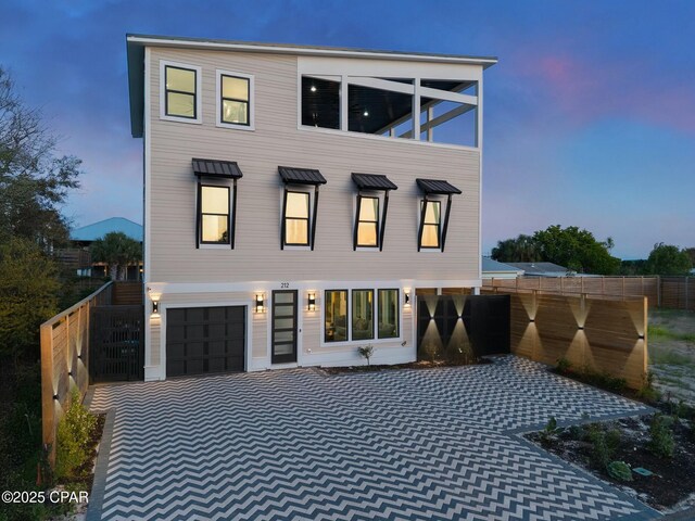 208 George C Wallace, Panama City Beach, FL 32413 - contemporary home with a garage, fence, and decorative driveway