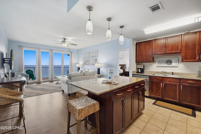 9860 S Thomas Dr Unit 1824, Panama City Beach, FL 32408 - kitchen with dishwasher, light stone counters, ceiling fan, and decorative light fixtures