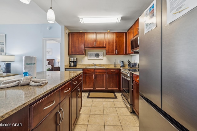 9860 S Thomas Dr Unit 1824, Panama City Beach, FL 32408 - kitchen with stainless steel appliances, light stone counters, light tile patterned floors, pendant lighting, and dark brown cabinets