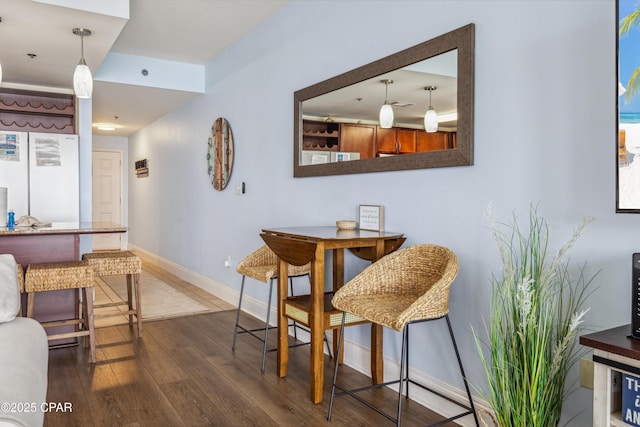 9860 S Thomas Dr Unit 1824, Panama City Beach, FL 32408 - dining area featuring dark wood finished floors and baseboards