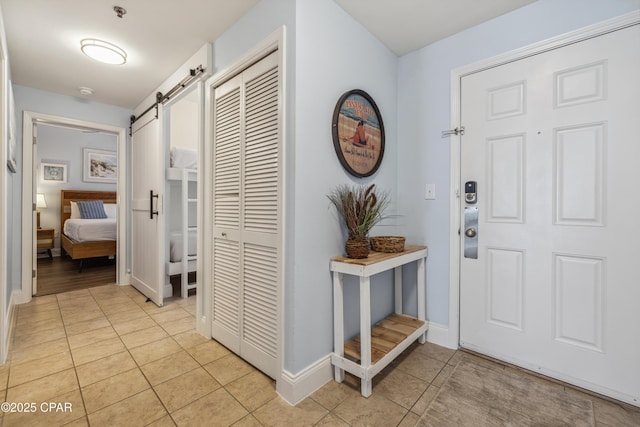 9860 S Thomas Dr Unit 1824, Panama City Beach, FL 32408 - foyer entrance with a barn door and light tile patterned floors