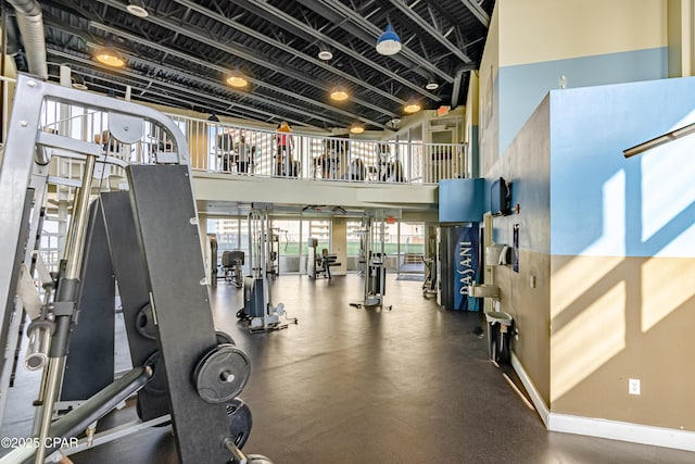 9860 S Thomas Dr Unit 1824, Panama City Beach, FL 32408 - exercise room with a high ceiling and baseboards