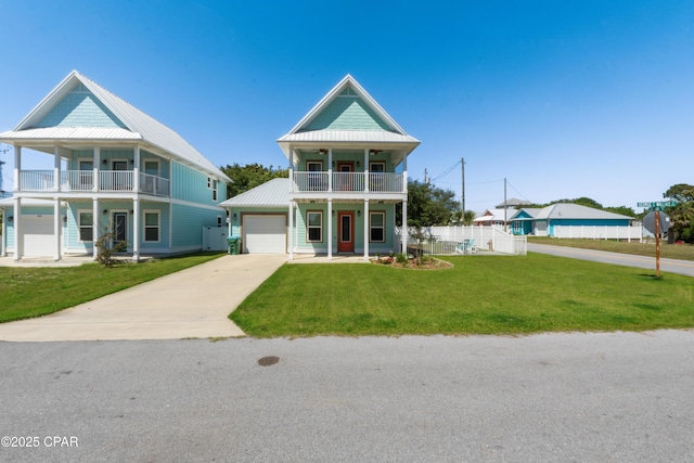 111 George C Wallace Blvd, Panama City Beach, FL 32413 - view of front of home with a balcony, covered porch, driveway, metal roof, and a garage