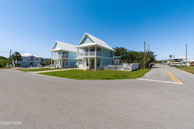 111 George C Wallace Blvd, Panama City Beach, FL 32413 - view of front of house with a balcony, driveway, an attached garage, and metal roof