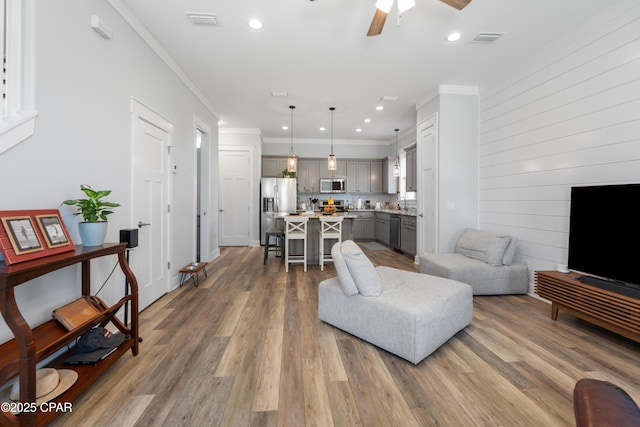 111 George C Wallace Blvd, Panama City Beach, FL 32413 - living room featuring wood finished floors, crown molding, a ceiling fan, and recessed lighting