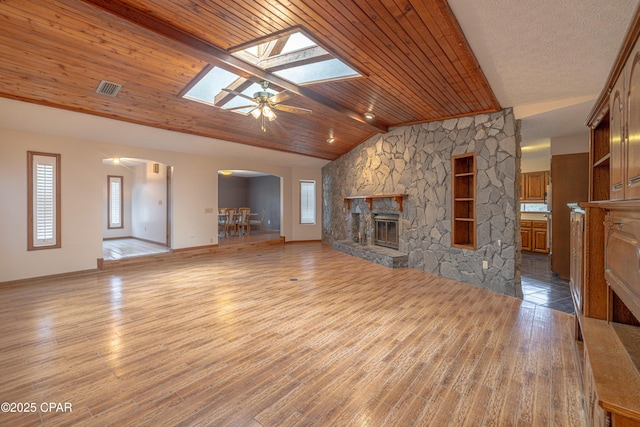 2324 Raintree Pl, Lynn Haven, FL 32444 - unfurnished living room with a fireplace, arched walkways, lofted ceiling, healthy amount of natural light, and a skylight
