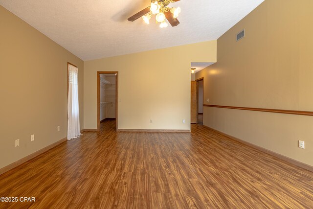 2324 Raintree Pl, Lynn Haven, FL 32444 - spare room featuring ceiling fan, wood finished floors, vaulted ceiling, and baseboards