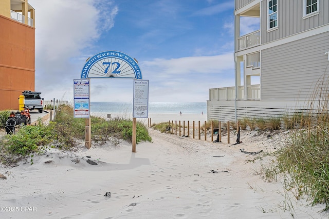 surrounding community featuring view of water and beach
