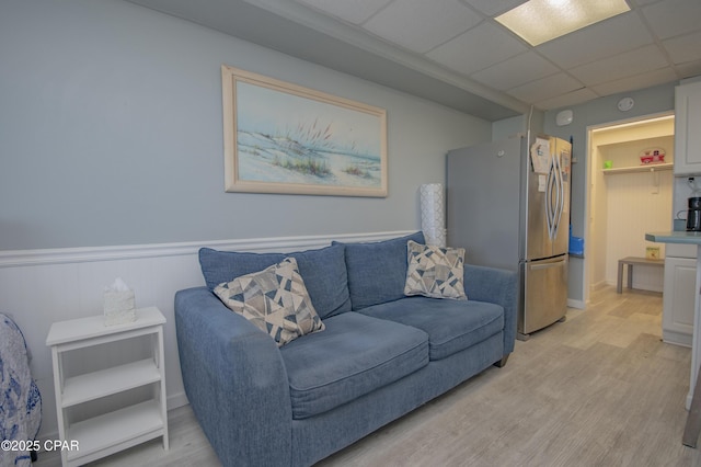 14401 Front Beach Rd Unit 206, Panama City Beach, FL 32413 - living area with light wood-style flooring, a wainscoted wall, and a paneled ceiling