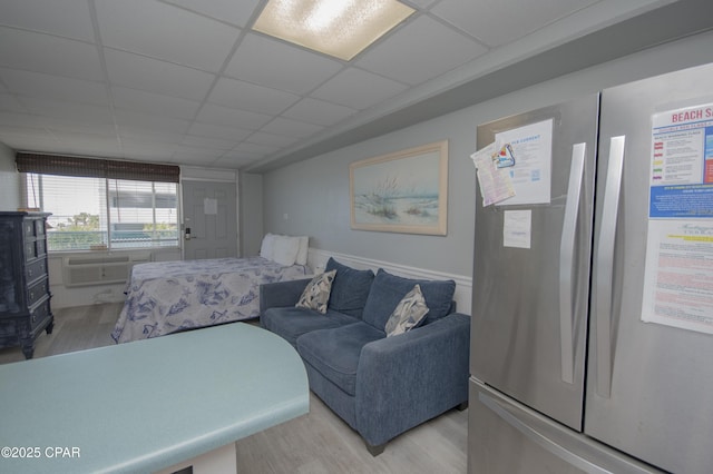 14401 Front Beach Rd Unit 206, Panama City Beach, FL 32413 - living room with light wood-type flooring, a paneled ceiling, and an AC wall unit