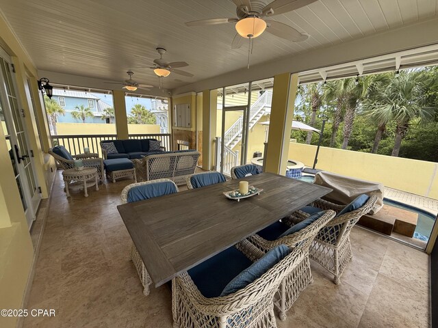 sunroom / solarium featuring an outdoor hangout area, ceiling fan, and outdoor dining space