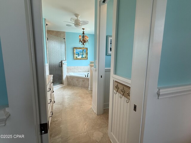full bath with a stall shower, a bath, a ceiling fan, and vanity
