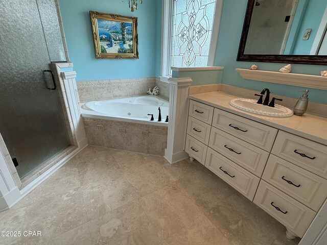 bathroom with a whirlpool tub, a shower stall, and vanity
