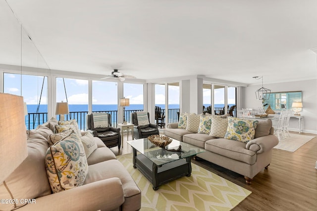 6905 Thomas Dr Unit 807, Panama City Beach, FL 32408 - living room with light wood-type flooring, ceiling fan, a water view, and baseboards