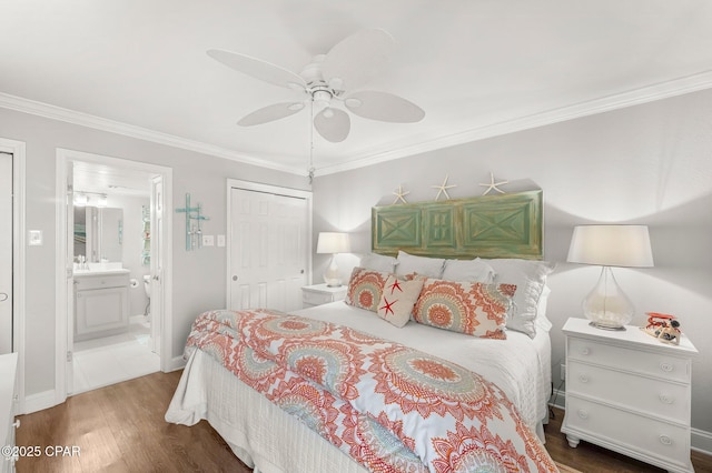 6905 Thomas Dr Unit 807, Panama City Beach, FL 32408 - bedroom with ornamental molding, wood finished floors, a sink, a closet, and ensuite bathroom