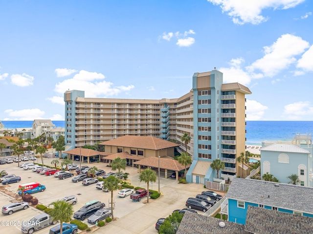 6905 Thomas Dr Unit 807, Panama City Beach, FL 32408 - view of building exterior with uncovered parking and a water view