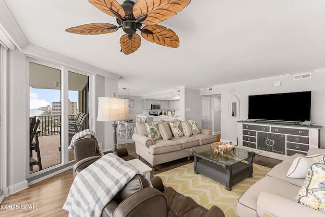 6905 Thomas Dr Unit 807, Panama City Beach, FL 32408 - living area featuring wood finished floors, a ceiling fan, ornamental molding, and baseboards