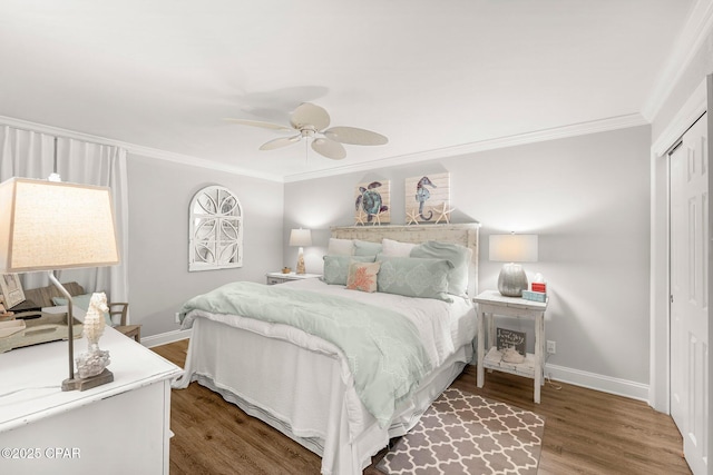 6905 Thomas Dr Unit 807, Panama City Beach, FL 32408 - bedroom with crown molding, baseboards, wood finished floors, a closet, and a ceiling fan