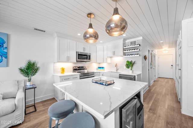 17735 Front Beach Rd Unit 4, Panama City Beach, FL 32413 - kitchen with stainless steel appliances, a sink, wooden ceiling, white cabinets, and recessed lighting