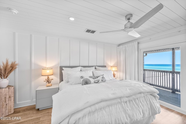 17735 Front Beach Rd Unit 4, Panama City Beach, FL 32413 - bedroom featuring access to outside, wood ceiling, a water view, light wood-type flooring, and ceiling fan