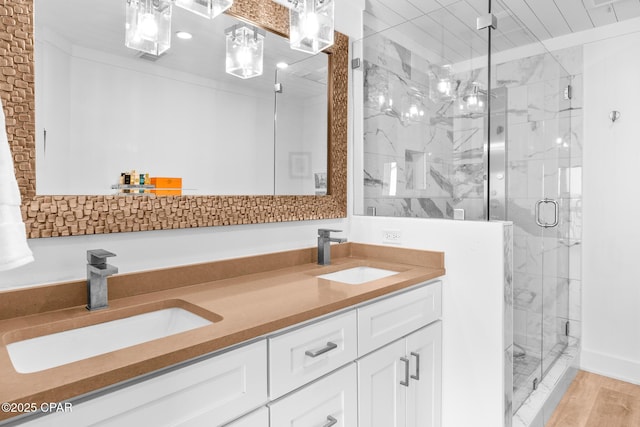 17735 Front Beach Rd Unit 4, Panama City Beach, FL 32413 - full bathroom featuring a marble finish shower, double vanity, and wood finished floors