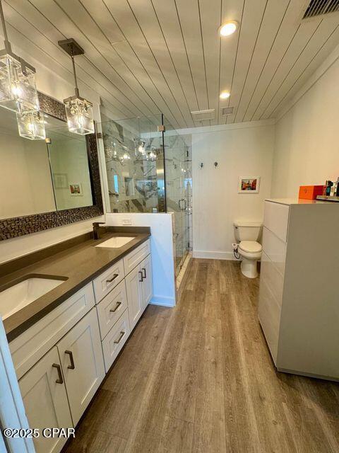 17735 Front Beach Rd Unit 4, Panama City Beach, FL 32413 - bathroom featuring toilet, a shower stall, double vanity, wood finished floors, and wood ceiling