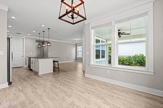 3104 Heartleaf E Ave, Panama City, FL 32405 - kitchen with open floor plan, dishwashing machine, baseboards, recessed lighting, and a breakfast bar area
